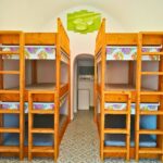 hostel dorm room with wooden bunk beds
