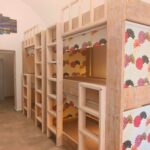 Wooden bunk beds in a clean hostel dorm room