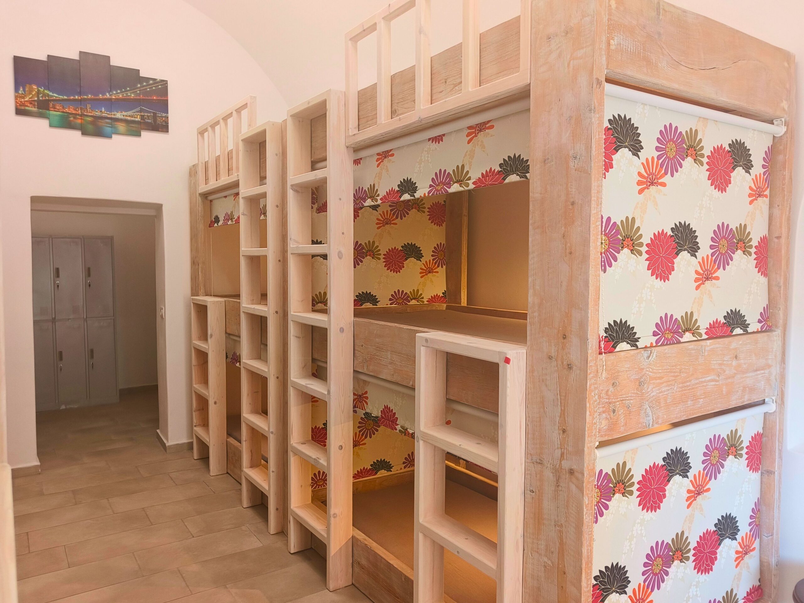Wooden bunk beds in a clean hostel dorm room